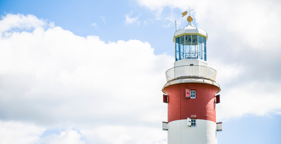 The top of Smeaton's Tower with blue skies and clouds in the background 